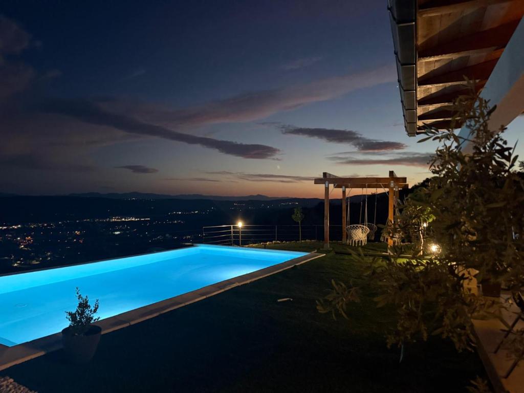 a swimming pool at night with a view at Villa Infinity View in Široki Brijeg