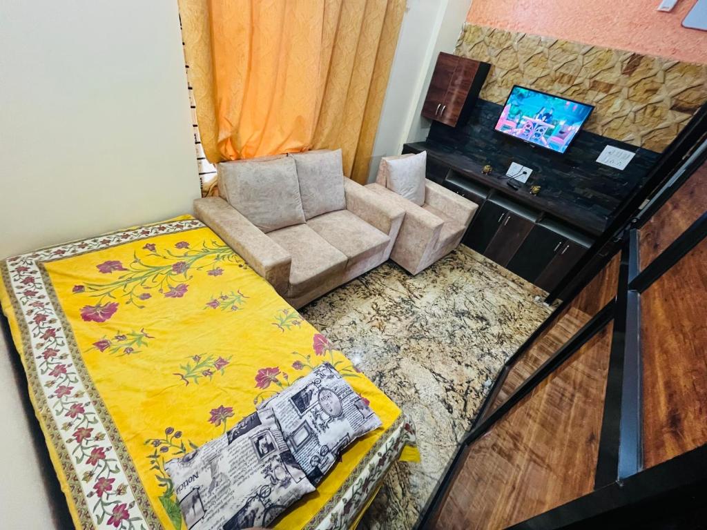 an overhead view of a living room with a bed and a chair at Kejriwals Vaikunth 35A in Bangalore
