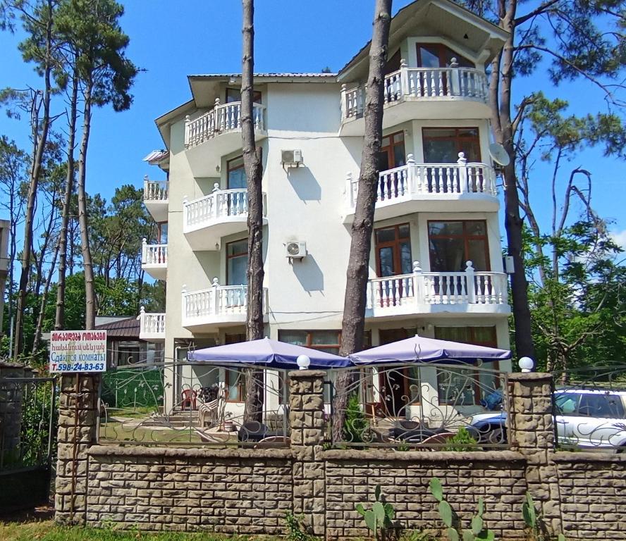 a building with umbrellas in front of it at Shekvetili Babi in Shekhvetili