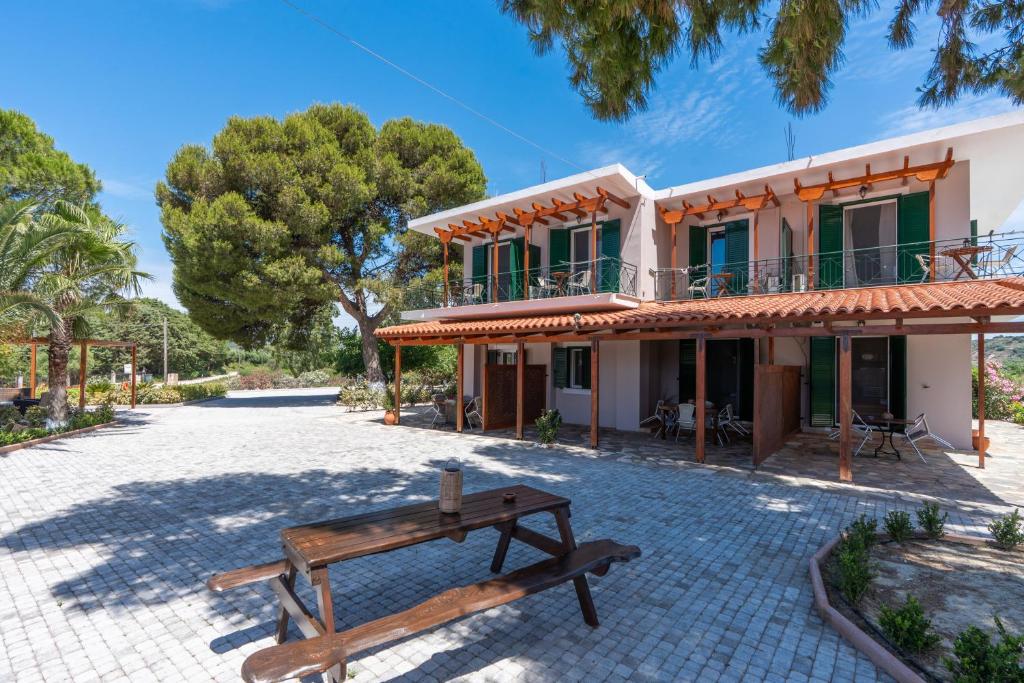 a house with a bench in front of it at Synodinos Studios in Lixouri