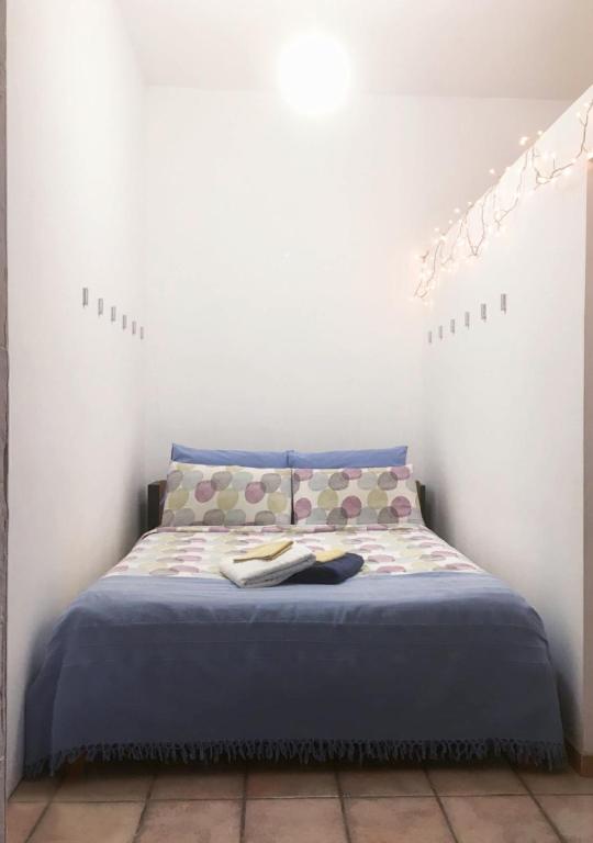 a bedroom with a bed with a blue comforter at Cosy Open Space Apartment Bari in Bari