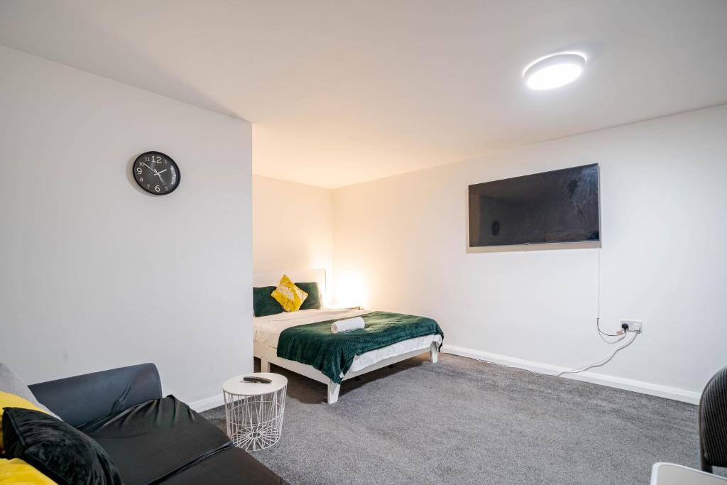 a living room with a bed and a couch at Studio Apartment Fully Equipeed with WiFi and Netflix in Ilkeston