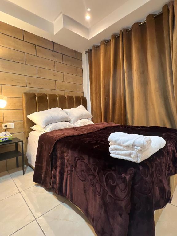 a bedroom with a bed with two towels on it at Modern Studio in Kenitra