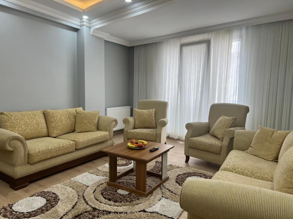 a living room with couches and chairs and a table at Bediroğlu Airport Apart in Arnavutköy