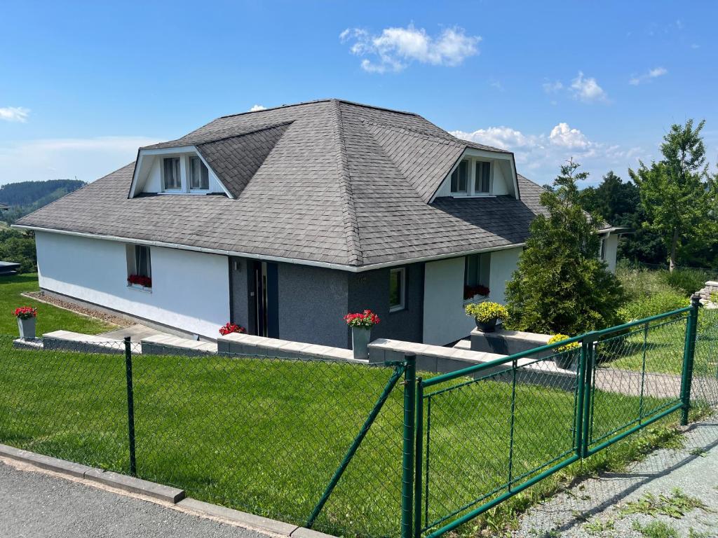 a house with a metal fence in front of it at Apartman Na Bubnu in Náchod