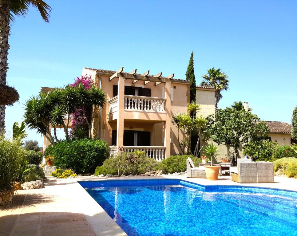 a house with a swimming pool in front of a house at Finca Alqueria Fosca in Campos