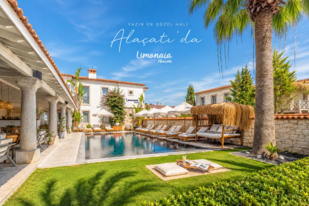 a villa with a swimming pool and palm trees at Alaçatı Limonaia Hotel in Alaçatı