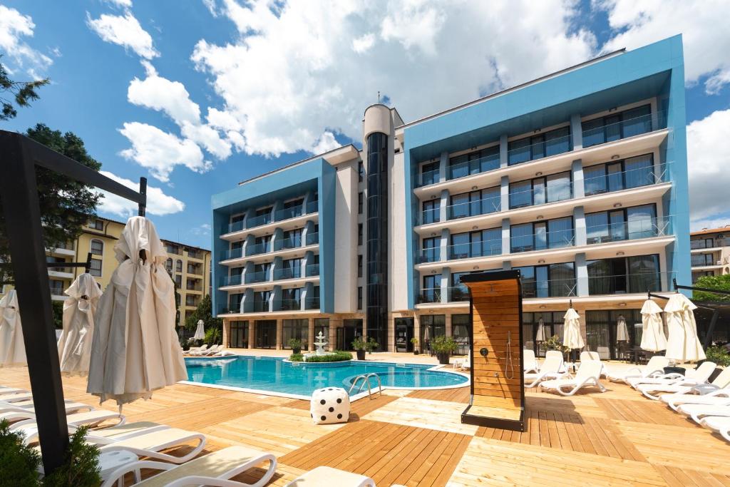 a hotel with a swimming pool in front of a building at Hotel Pautalia in Sunny Beach