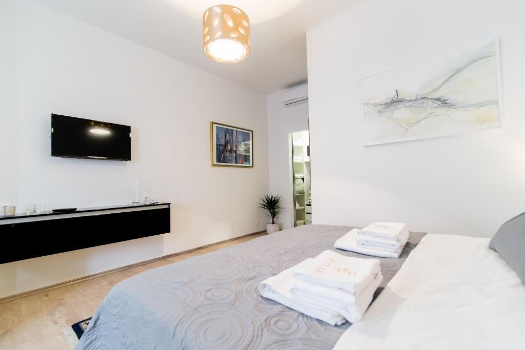 Postel nebo postele na pokoji v ubytování Polai Center Apartments