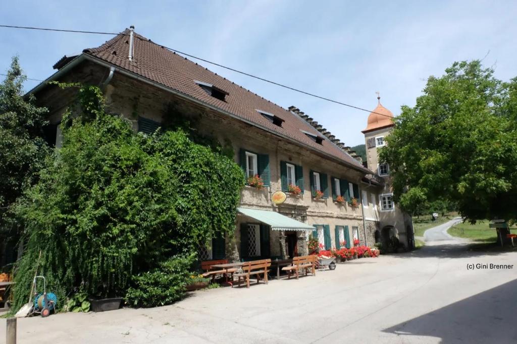 a large building with a tree in front of it at Gasthaus Kopper in Guttaring
