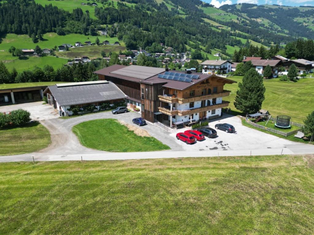 an aerial view of a large building with a parking lot at Mannharthof Apartments in Westendorf