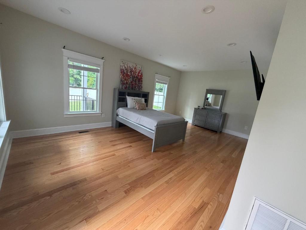 a bedroom with a bed and a wooden floor at Room in private house for Rent in Nice Neighborhood in Midlothian