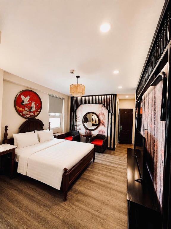 a hotel room with a bed and a television at Halo Boutique Ben Thanh Hotel in Ho Chi Minh City