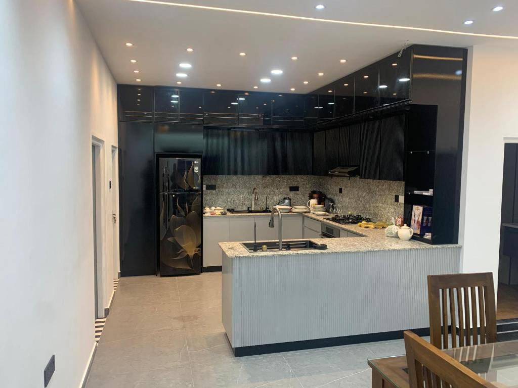a kitchen with black cabinets and a white counter top at Elysian Ridge Villa in Welimada