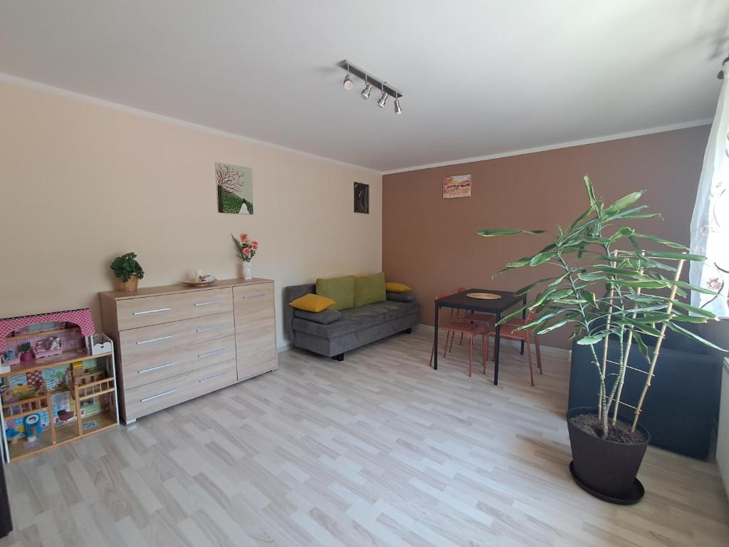 a living room with a couch and a table at U Podnóża Gór in Nowa Ruda