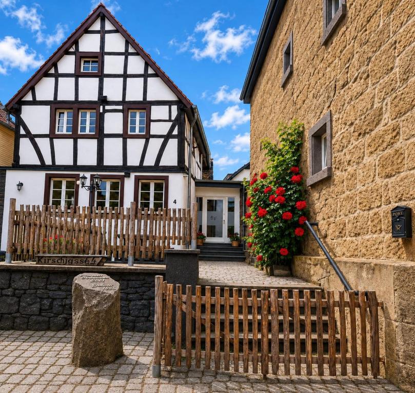a house with a fence in front of it at RawertsRefugium in Bell