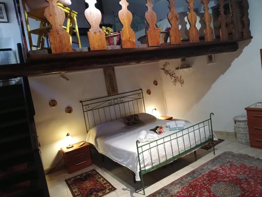 a bedroom with a bed and a mirror on the wall at La Dimora del 1700 in Tivoli