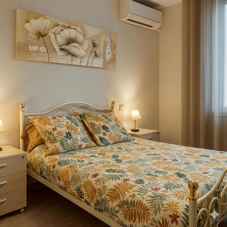 a bedroom with a bed with a colorful comforter at Hostel-Élisée-Perpignan in Perpignan