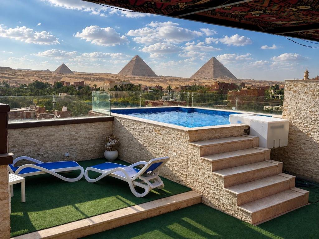 a view of the pyramids from a house with a swimming pool at Marquis Pyramids Hotel in Cairo
