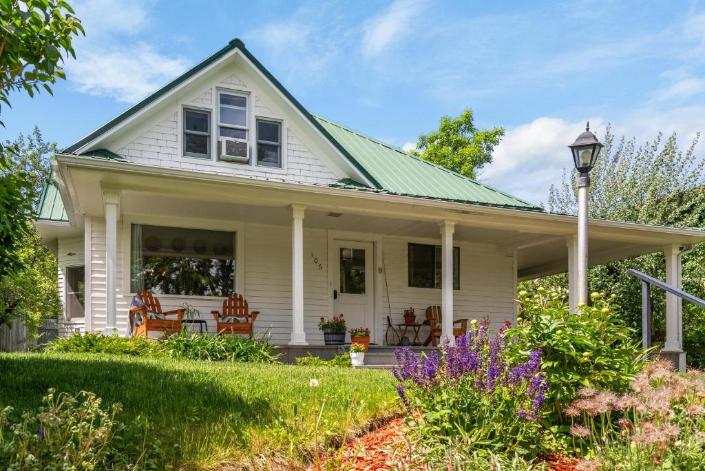 a white house with a green roof at 7th Street Bungalow in Livingston