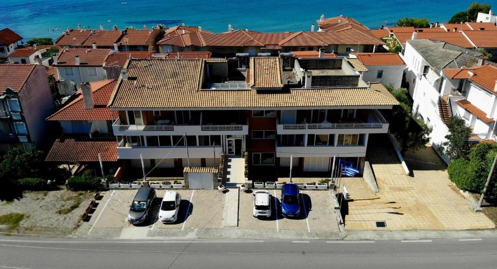 an aerial view of a house with cars parked in front at Fenix Apartments in Mola Kalyva