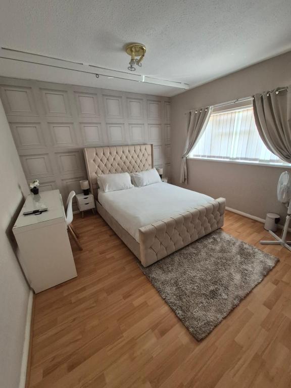 a bedroom with a large bed and a window at Quiet and professional friendly in Cardiff