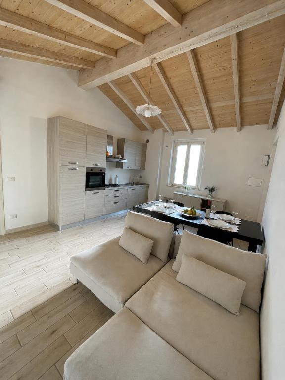 a living room with a couch and a kitchen at Casa vacanze indipendente in Follonica