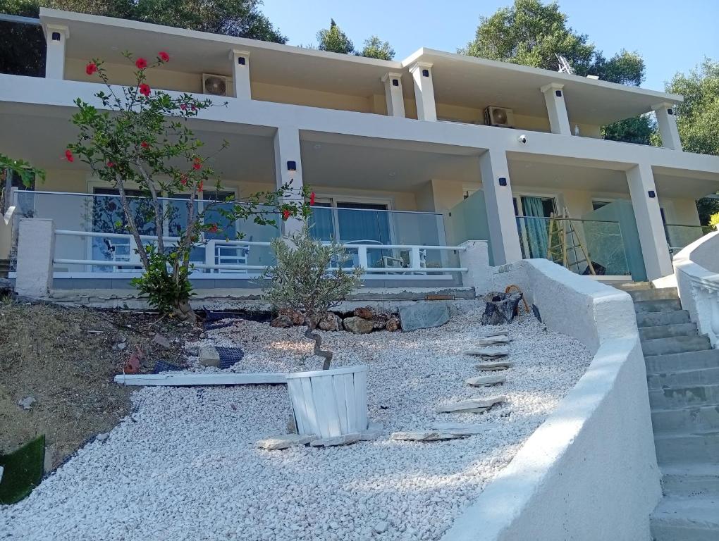 a large house with a pathway in front of it at Poseidon Complex in Paleokastritsa