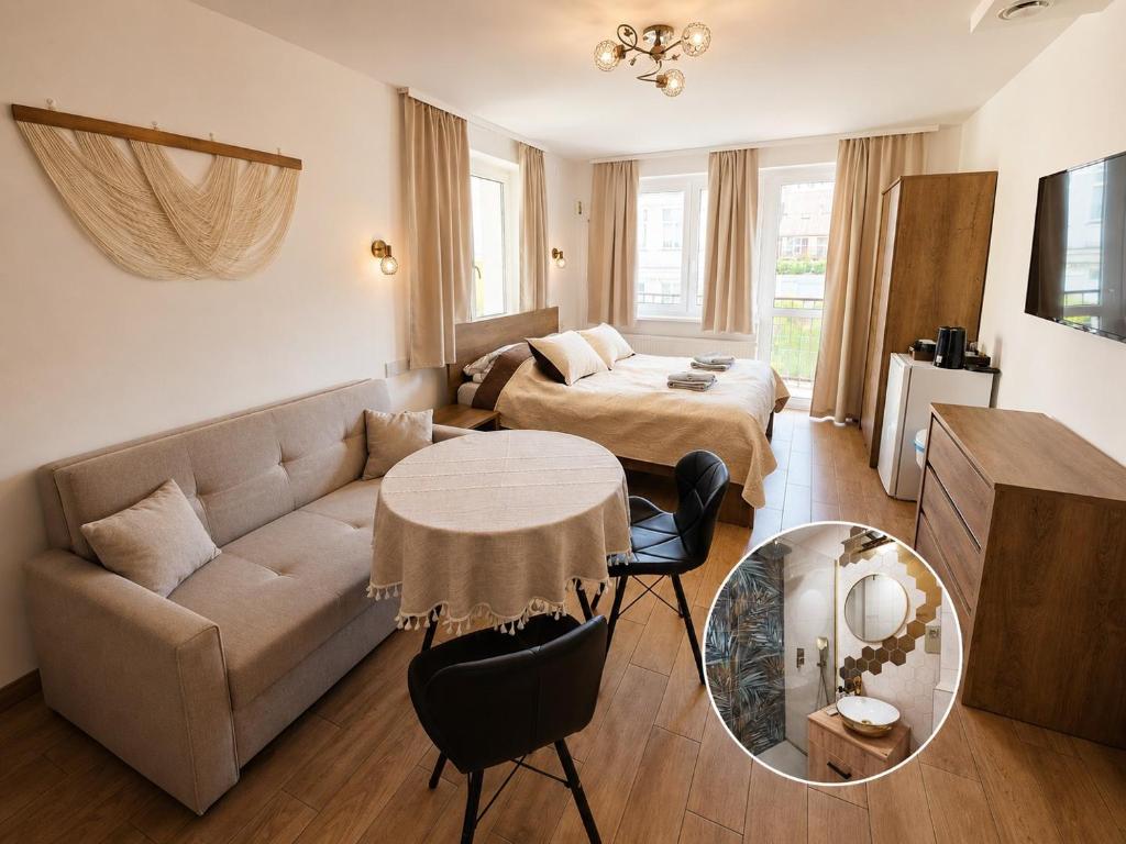 a living room with a couch and a bed and a table at Villa Krysia 50 m do morza in Międzyzdroje