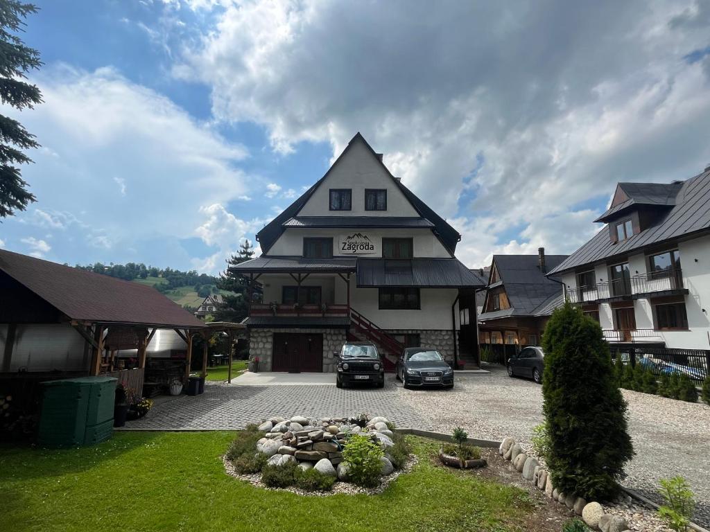 a large building with cars parked in a parking lot at Spokojna Zagroda in Biały Dunajec