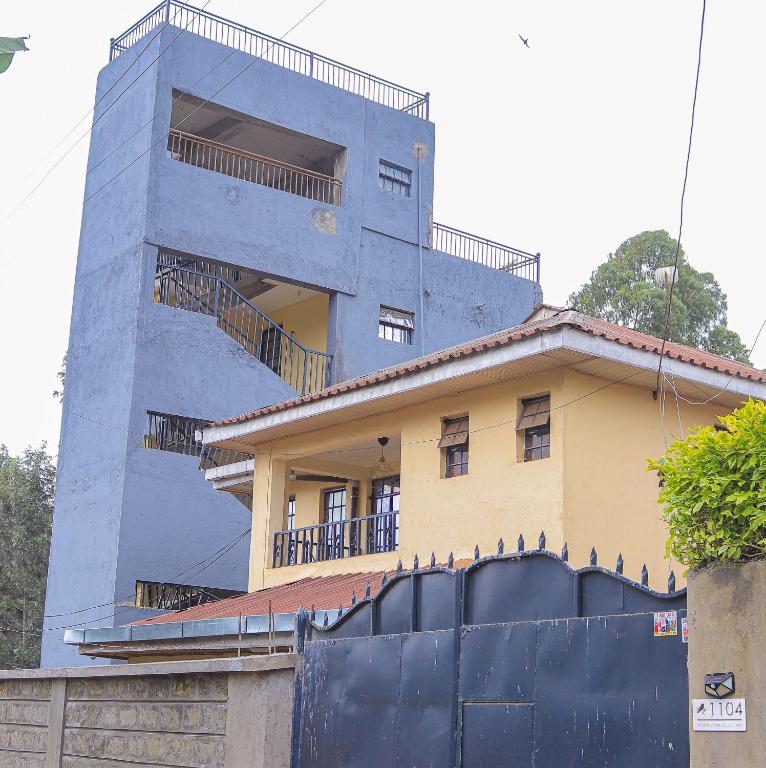 a blue building with balconies on top of it at Countryside Apartment 1 in Kiambu