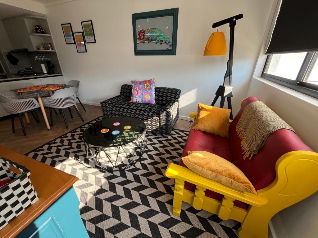 a living room with a couch and a table at The Happy Chameleon in George