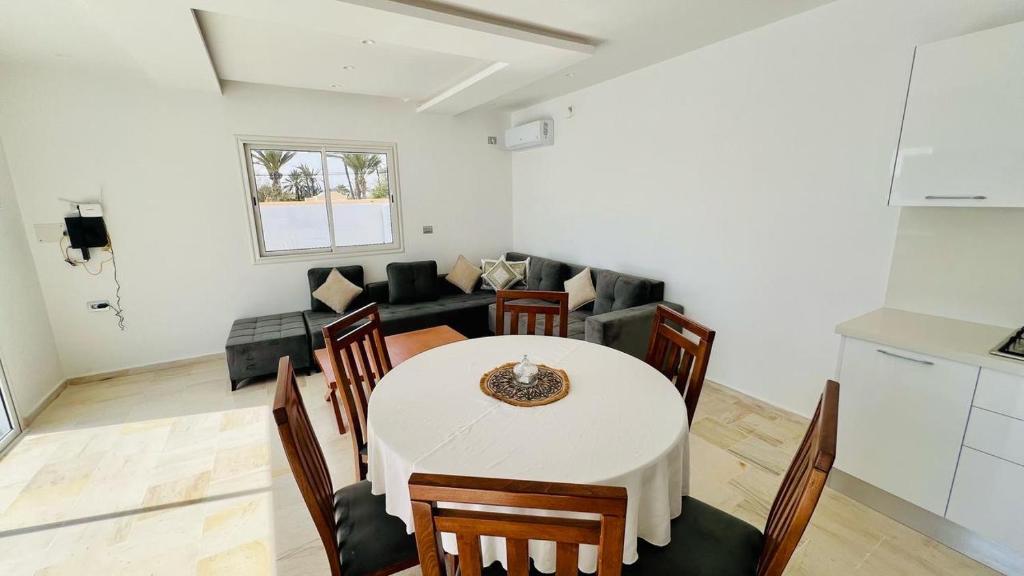a living room with a table and a couch at Corail in Djerba