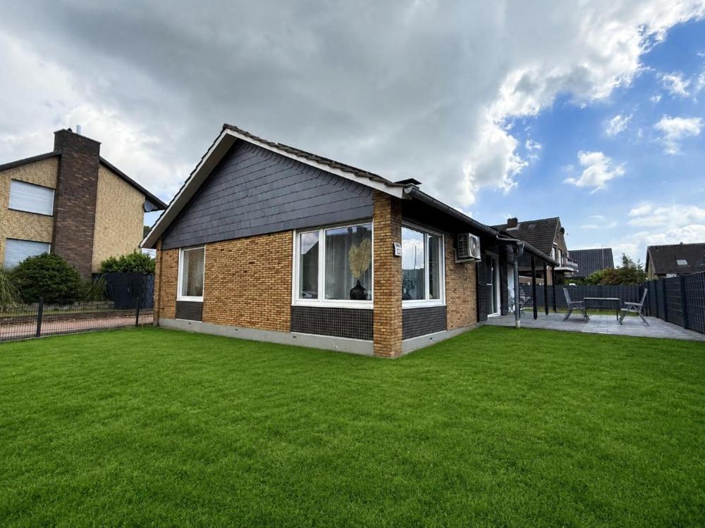a house with a large lawn in front of it at Karolinger Stay in Emmerich