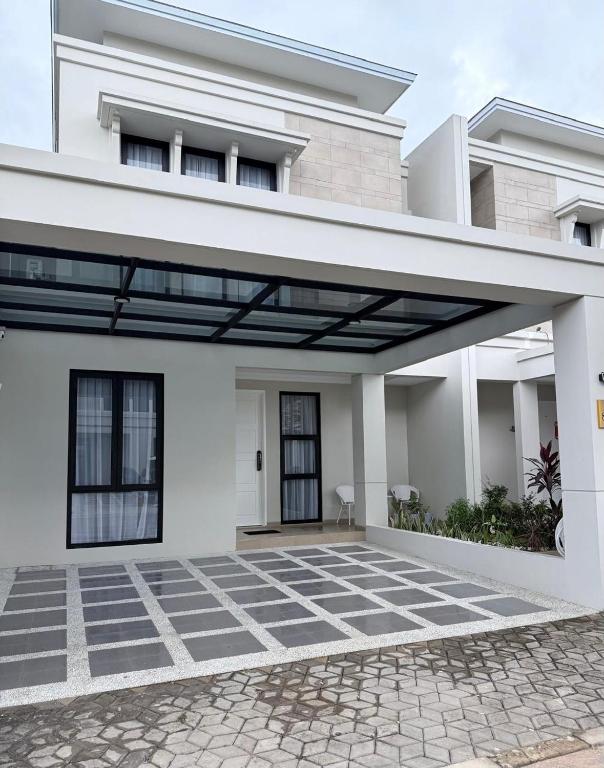 a white house with awning in front of it at Noble Cove Batam in Pulau Sembakau Kecil