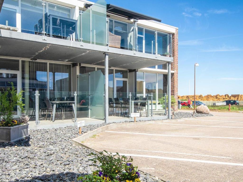a building with a lot of windows and a parking lot at 5 star holiday home in Ringkøbing in Ringkøbing