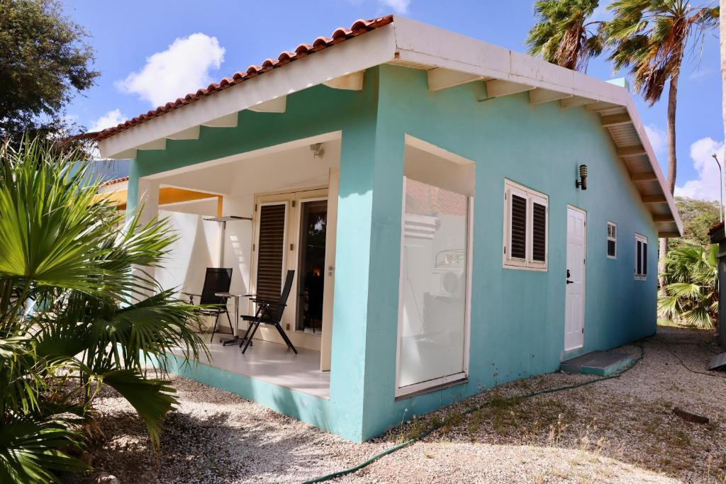 a small blue and white house with a porch at Caribbean Court E1 in Kralendijk
