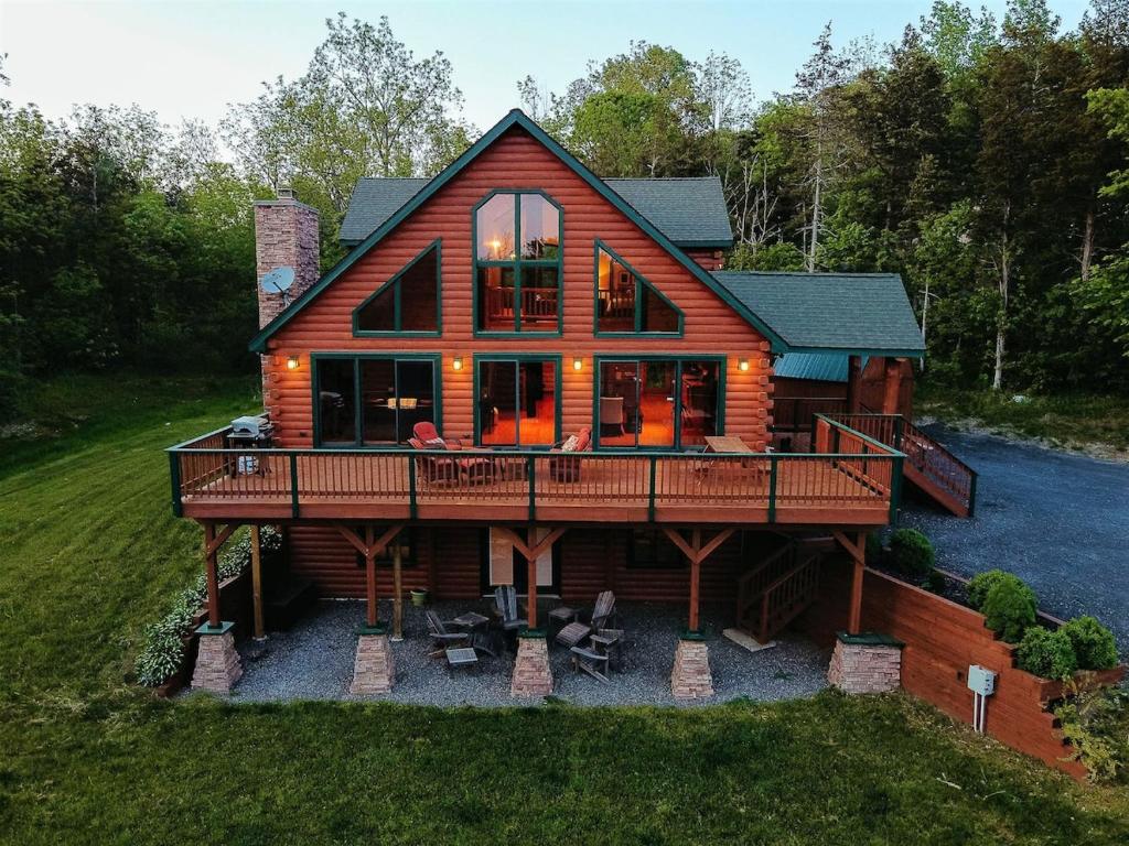 a large wooden house with a large deck at Red Tara Sanctuary in Catskill