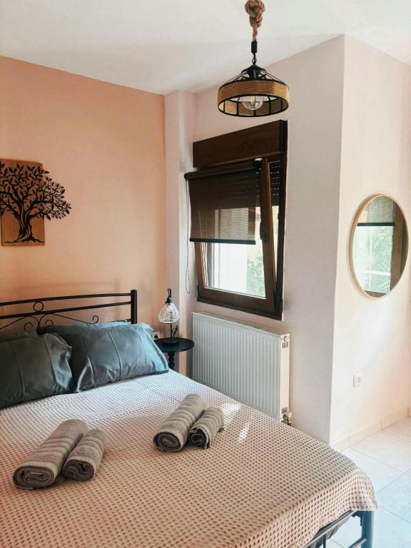a bedroom with a bed with two towels on it at Sofia in Komotini