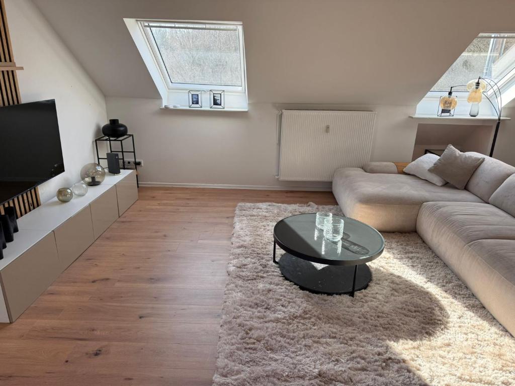 a living room with a couch and a table at Ferienwohnung Monteurwohnung in Lüdenscheid