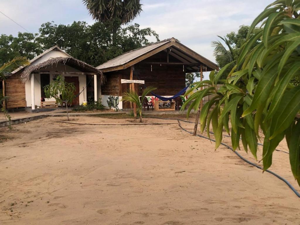 a house on the side of a dirt road at Thambili cabanas whisky point in Arugam Bay
