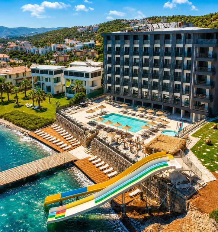 an image of a resort with a water slide at Grand Rimedya Hotel in Karabağ