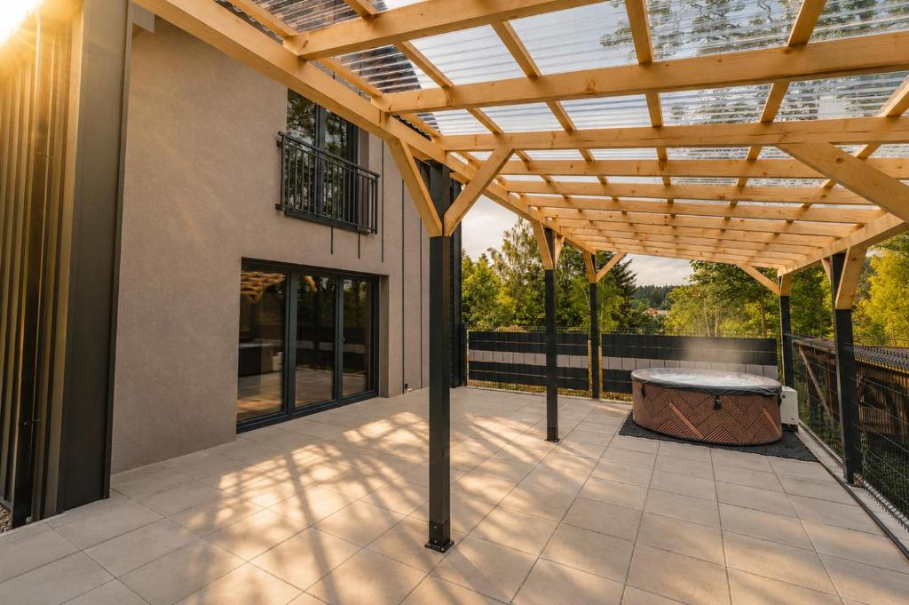 an outdoor patio with a wooden pergola at SenWood House in Zubrzyca Dolna