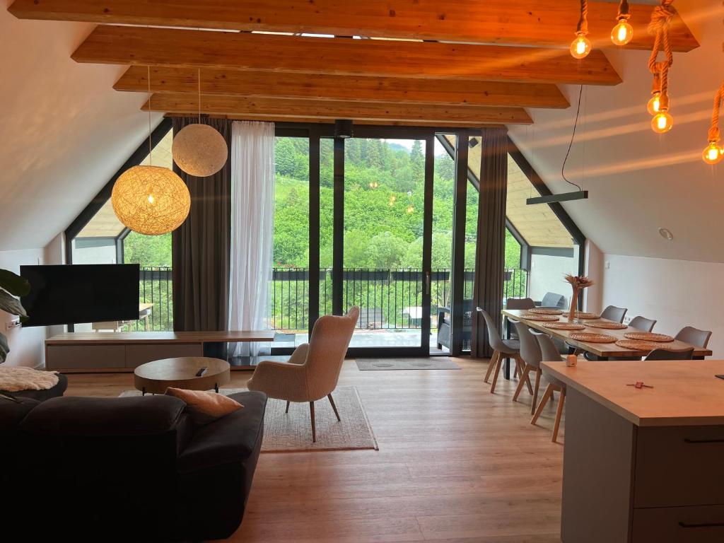 a living room with a table and chairs at JAMY HOUSE Apartmán in Habovka