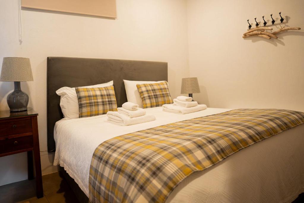 a bedroom with a bed with two towels on it at Provesende Douro Villas -Pateo Douro in Provesende