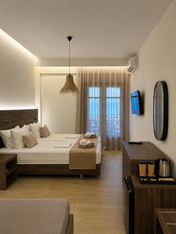 a bedroom with a large bed and a window at Este Luxury Apartments in Kriopigi