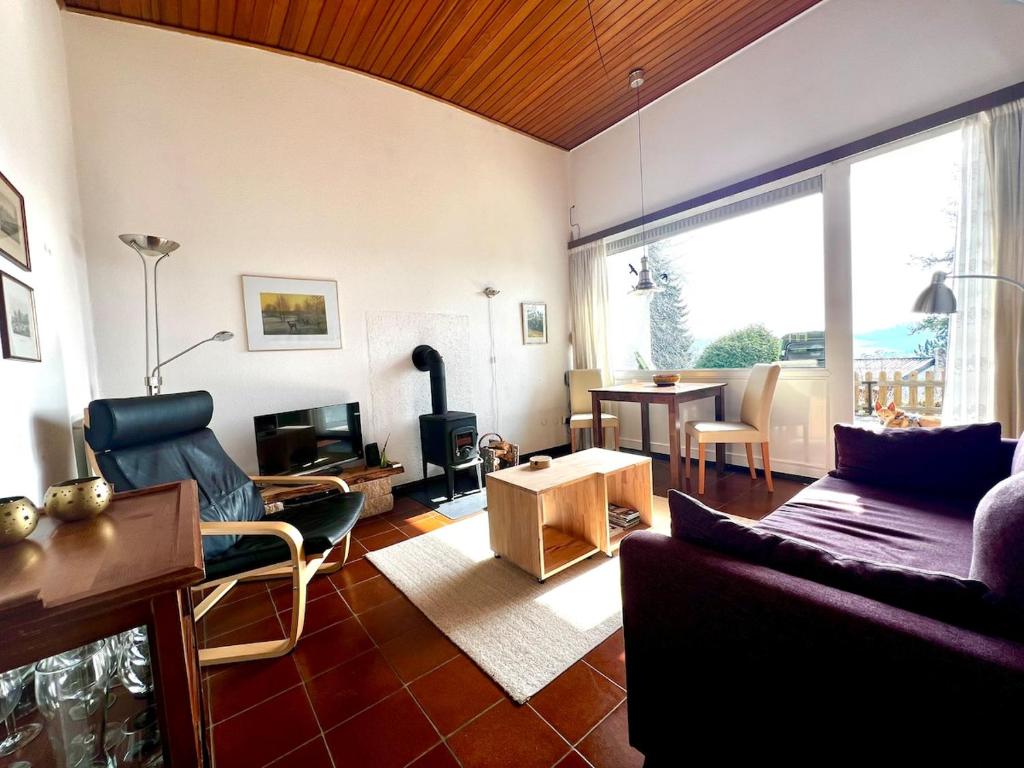 a living room with a couch and a table at Cozy cottage in Lichtenau