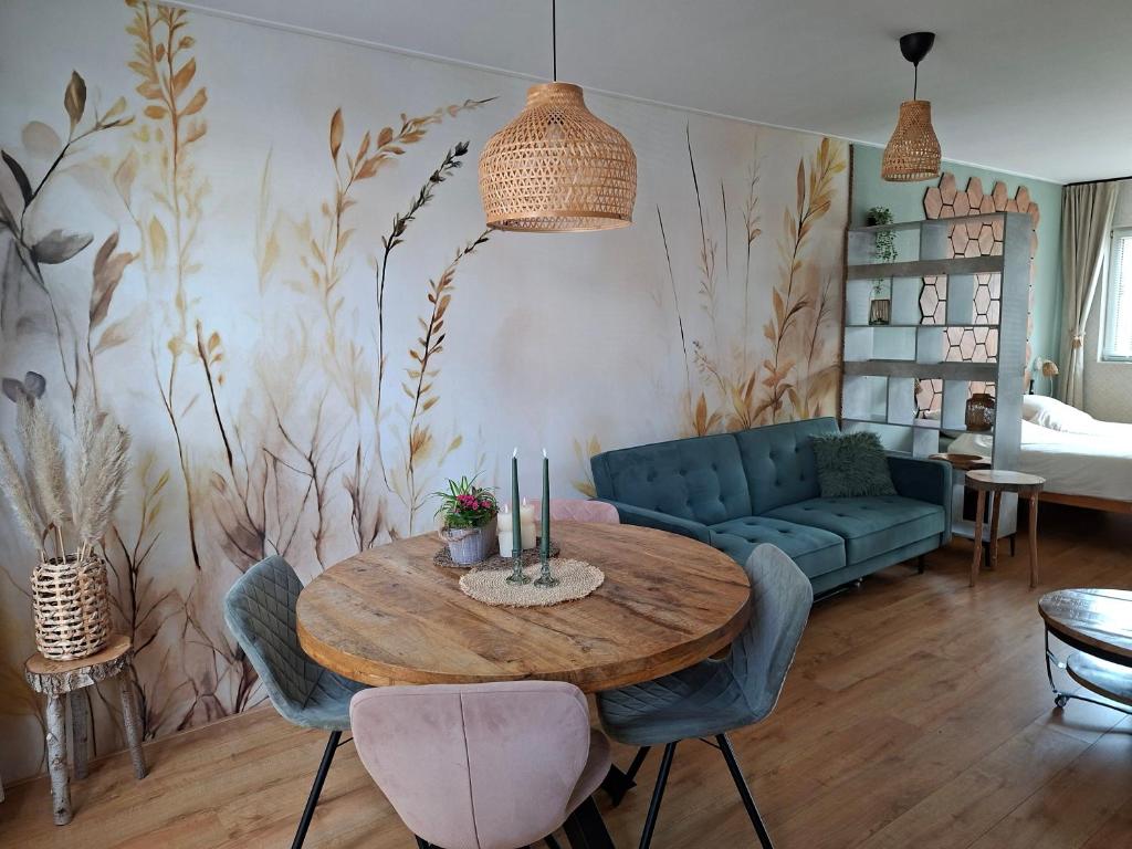 a living room with a table and a couch at Sfeervolle Studio 't kapucijntje Ossendrecht, near Antwerp in Ossendrecht