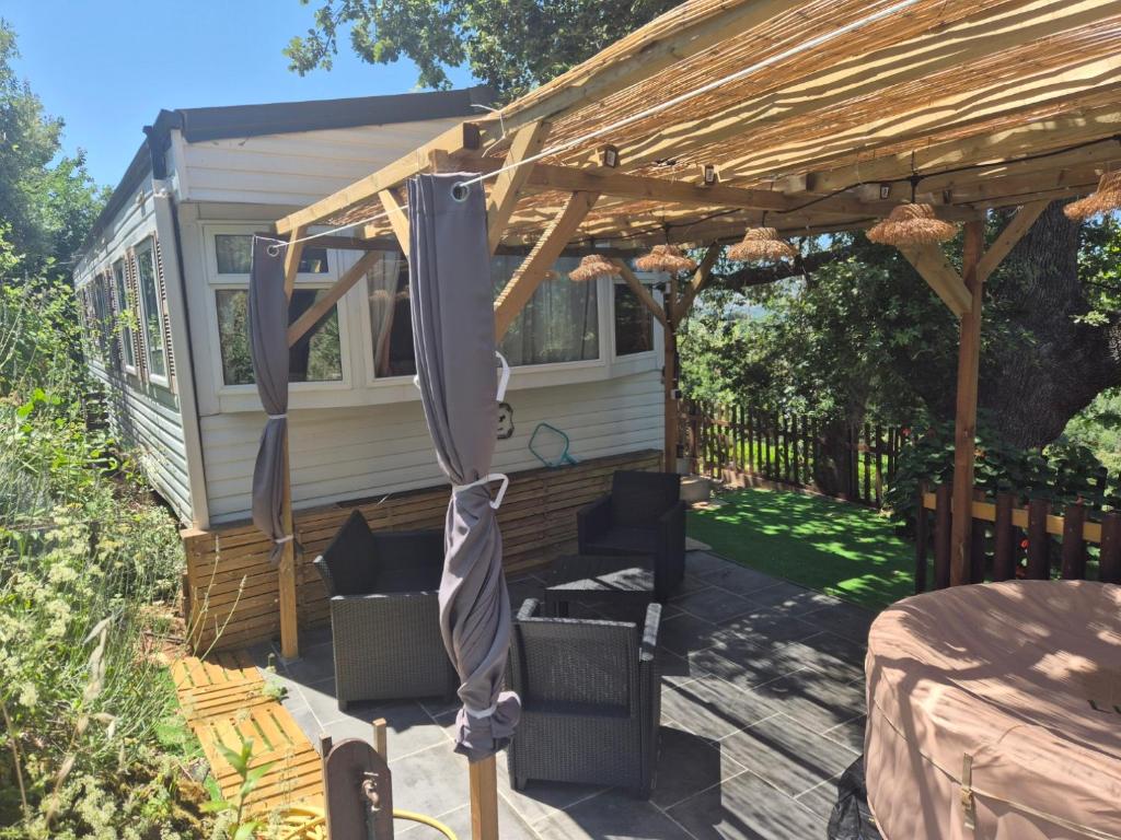 a patio with a wooden pergola at Casa à leccia in Rapale