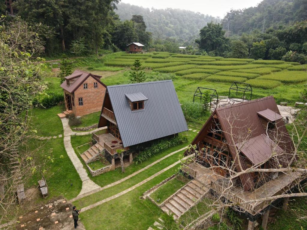 an overhead view of a farm with a house and a field at Ban Kaew Mo Ra Glamping & Restaurant in Pang Mapha